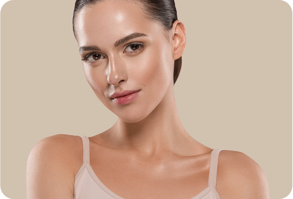 Young woman with glowing skin, slicked-back hair, wearing a camisole.